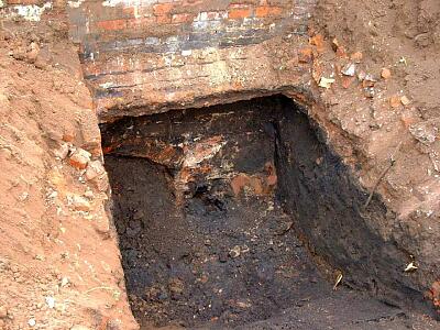 Excavated courses of the medieval city wall, Bonds Hospital, Hill Street, with inserted brick arch  © Coventry City Council